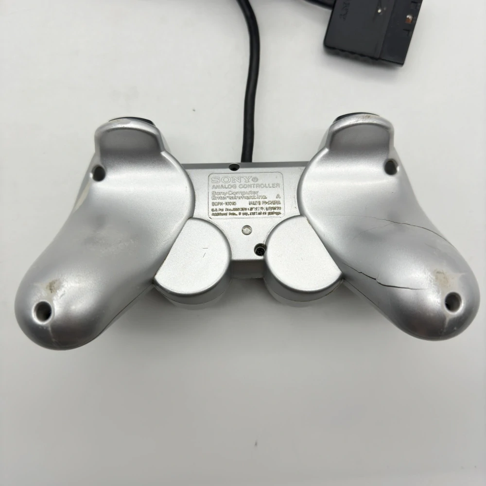Playstation 2 ovládač (strieborný, popraskaný)